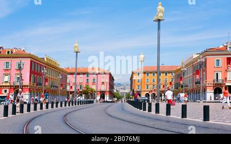 NICE, FRANCE - JUNE 4, 2017: A view of the Place Massena square in Nice, France, with the tramway rails in the foreground. This is the main public squ Stock Photo