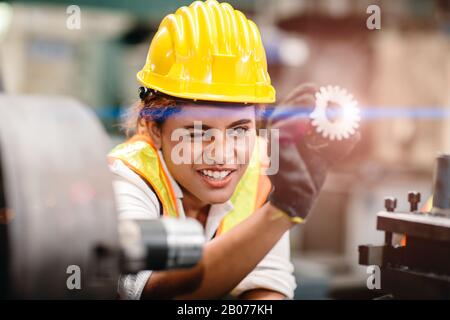engineer worker looking at steel gear part, working precise and most accuracy high performance doing best job. Stock Photo