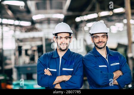 Engineering team portrait smile in heavy industry factory men working together. Arm Crossed fold with space. Stock Photo