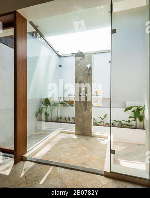 Glass shower protruding into courtyard Stock Photo