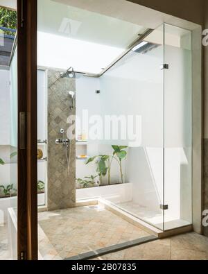 Glass shower protruding into courtyard Stock Photo