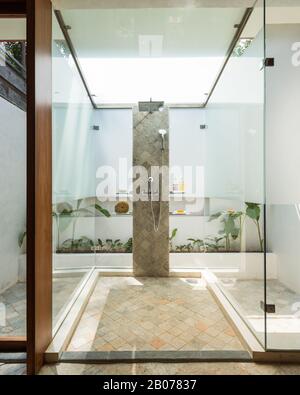 Glass shower protruding into courtyard Stock Photo