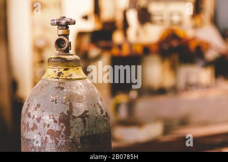 closeup old rusty gas tank valve, danger unsafety industry oxygen cylinder. Stock Photo