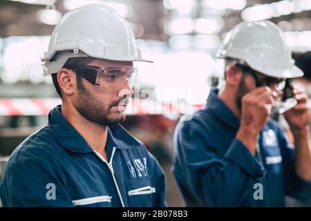 Head of engineer, worker leader portrait self confidence and professional look wearing safty glasses and white helmet. Stock Photo