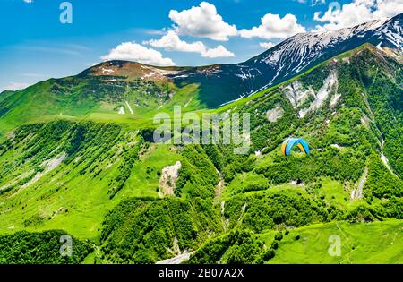 Paragliding over the Caucasus Mountains at Gudauri, Georgia Stock Photo