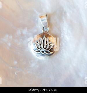 Sterling silver pendant in shape of mandala with lotus blossom Stock Photo
