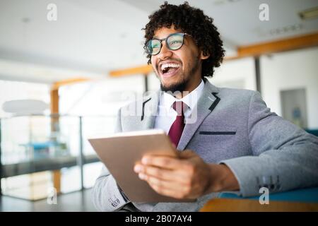 Portrait of man in office using tablet Stock Photo