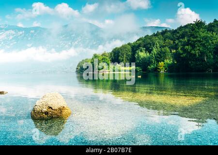 Lake Bohinj in Slovenia, beautiful scenic summer landscape of famous travel destination in Triglav national park in Alpine mountain range Stock Photo