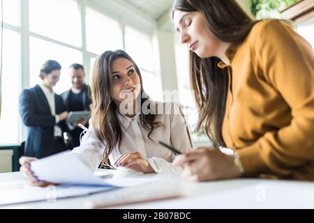 Multiethnic work group talk during casual office meeting, discuss business ideas sharing thoughts Stock Photo