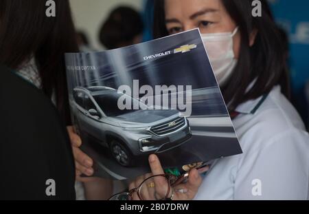 January 1, 2000, Bangkok, Thailand: A woman with a mask reads a brochure at the showroom..General Motors Company Limited and Chevrolet Sales announces the end of sales 2020 and offers reduced prices by 30-50% for Chevrolet vehicles in Thailand. (Credit Image: © Adisorn Chabsungnoen/SOPA Images via ZUMA Wire) Stock Photo