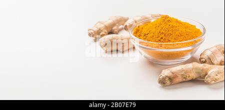 Turmeric powder with curcuma roots on white Stock Photo