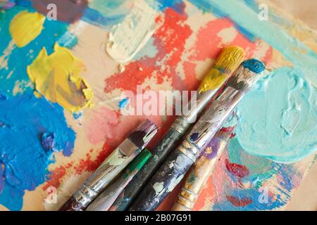 Close-up of finished watercolor painting with paintbrushes on the table Stock Photo