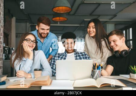 Education concept. Multinational teens enjoying group study Stock Photo
