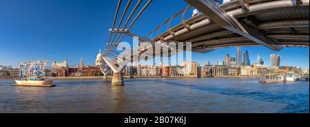 London, United Kingdom. Circa November 2019. Panorama of the Thames river with Millennium bridge and Saint Paul's Cathedral and the City skyline in th Stock Photo