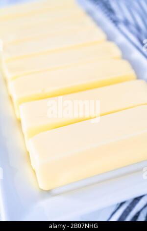 Organic sticks of butter at the room temperature. Stock Photo