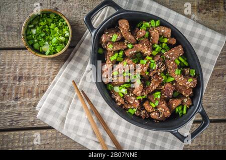 Korean BBQ dish Beef Bulgogi, with marinated rib eye beef meat slices. Traditional korean food recipe idea, copy space Stock Photo