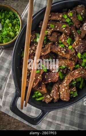 Korean BBQ dish Beef Bulgogi, with marinated rib eye beef meat slices. Traditional korean food recipe idea, copy space Stock Photo