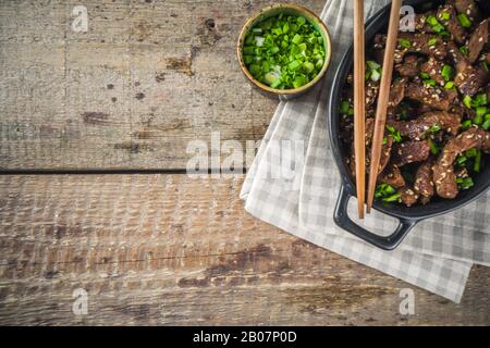 Korean BBQ dish Beef Bulgogi, with marinated rib eye beef meat slices. Traditional korean food recipe idea, copy space Stock Photo