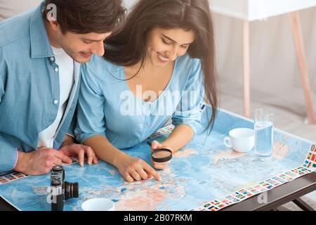 Preparation for vacation. Couple planning travel and looking map Stock Photo