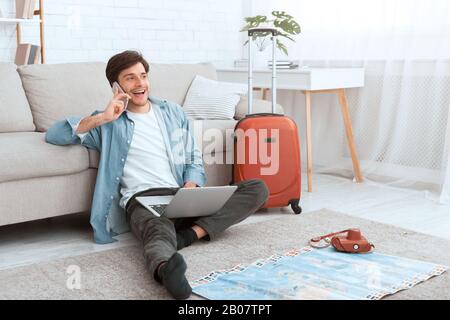 Consulting with travel agent. Man preparing for vacation Stock Photo