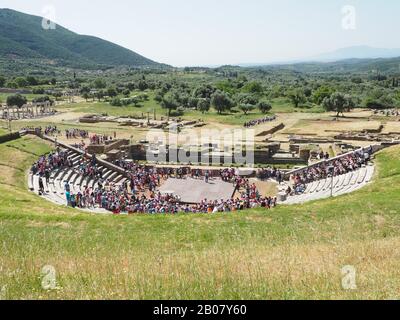 The theatre of Ancient Messene, Ithomi, Messini, Messenia, Peloponnese, Greece. School children leaving after an outdoor performance of a classic play Stock Photo
