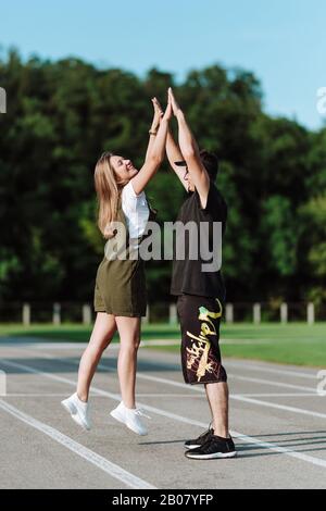 A young couple on a walk. The guy with the girl in the stadium Stock Photo