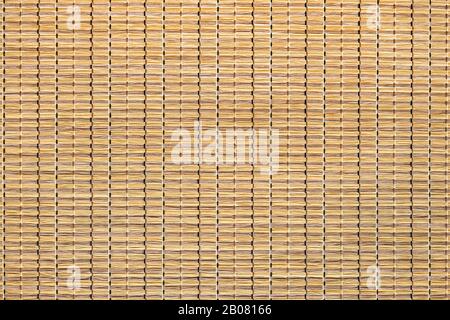 Rattan. Woven Mat made of cane or straw-yellow. Dry cane texture. Light yellow. Stock Photo