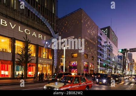 Japan, Honshu, Tokyo, Ginza, Chuo-dori Shopping Street at Night, Bvlgari and Louis Vuitton and Matsuya Department Stores Stock Photo