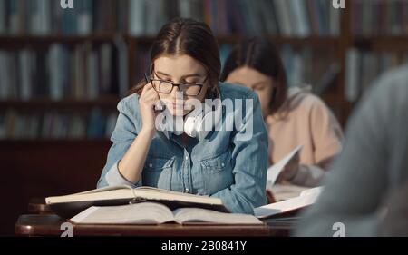Female student studying in library Stock Photo
