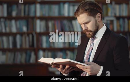 Business-looking man reading book Stock Photo