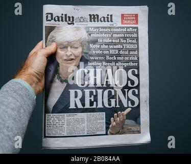 Paris, France - Mar 15, 2019: Male hand POV at the latest edition Daily Mail newspaper featuring breaking news about Brexit and Theresa May PM Stock Photo