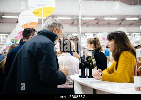 Strasbourg, France - Feb 16, 2020: Senior man tasting French wine at the Vignerons independant English: Independent winemakers of France wine fair for private and horeca customers Stock Photo
