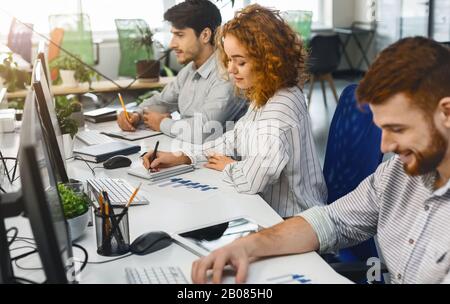Young professional team working on marketing strategy in office Stock Photo