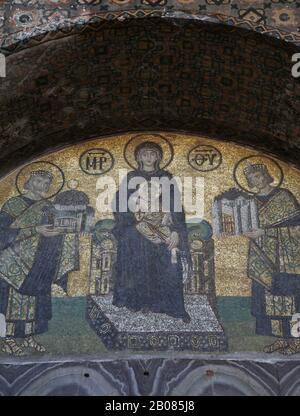 Turkey. Istanbul. Hagia Sofia. Byzatine mosaic. Virgin Mary with Jesus, emperors Constantine and Justinian. Tympanum. 994. Stock Photo