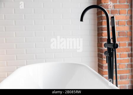 Black shower system for white loft style bathroom Stock Photo