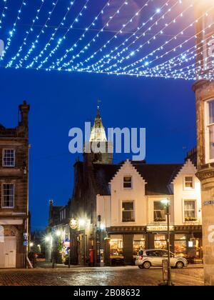 View towards St Salvators Tower from underneath fairy lights across Church Street in St Andrews Fife Scotland Stock Photo