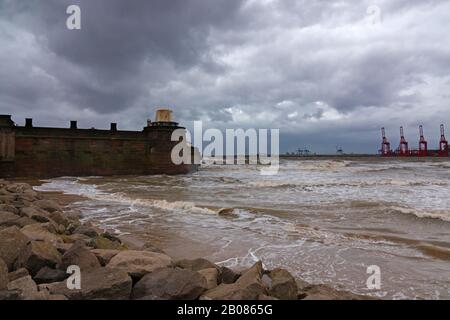 Looking across the River Mersey on a stormy day towards Liverpool 2 docks from New Brighton Wallasey UK with Fort Perch Rock in the foreground. Stock Photo