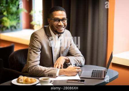 Black business man taking notes on the paper Stock Photo