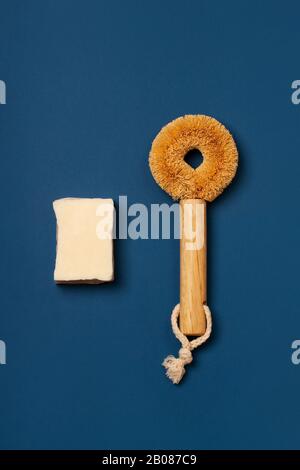 Eco-friendly cleaning kit. Organic soap and natural wooden brush with cactus bristles on a trendy blue background. Zero waste concept, plastic-free, eco-friendly shopping, vegan Stock Photo