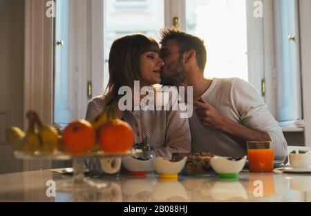 Happy couple making breakfast at home. Concept about lifestyle, healthy food and relationship Stock Photo
