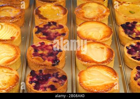 Pastries and fancy cakes on display in pastry shop / bakery Stock Photo