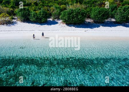 Couple spending time on a beutiful remote tropical island in the philippines. Concept about vacation and lifestyle. Aerial shot with the drone Stock Photo