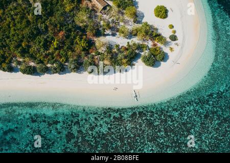 Couple spending time on a beutiful remote tropical island in the philippines. Concept about vacation and lifestyle. Aerial shot with the drone Stock Photo