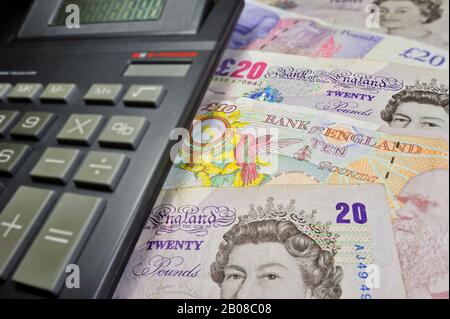 English banknotes in pound sterling and pocket calculator Stock Photo