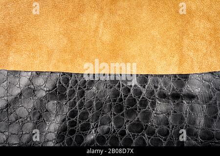 Brown leather and black artificial alligator skin textures background. Stock Photo