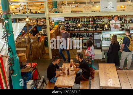 People gather for Street Food Thursdays at Markthalle Neun (Market Hall Nine) at Eisenbahnstrasse to enjoy organic street food. Kreuzberg, Berlin Stock Photo