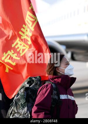 (200219) -- XI'AN, Feb. 19, 2020 (Xinhua) -- A medical team member waits to board the plane at Xianyang International Airport in Xi'an, northwest China's Shaanxi Province, Feb. 19, 2020. The 4th team of 145 medical workers from Shaanxi left for Hubei Province on Wednesday to aid the novel coronavirus control efforts there. (Xinhua/Li Yibo) Stock Photo