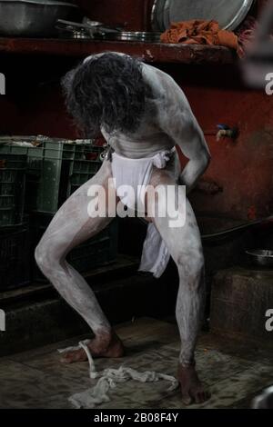 A Hindu holy man, or Naga sadhu,ties a cloth after smearing ashes on his body at the premises of Pashupatinath Temple ahead of the Shivaratri festival in Kathmandu, Nepal February 19, 2020. (Photo by Prabin Ranabhat/Pacific Press) Stock Photo