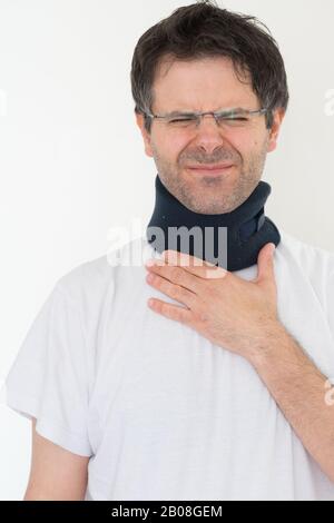 Man with medical collar for neck injury on white background. Stock Photo