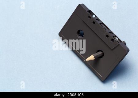 Pencil tool to rewind the tape cassettes on light gray background Stock Photo